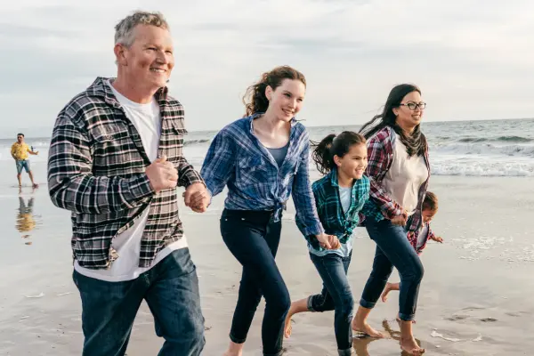 family running on beach